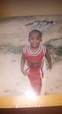 a photo of a young boy in a basketball uniform